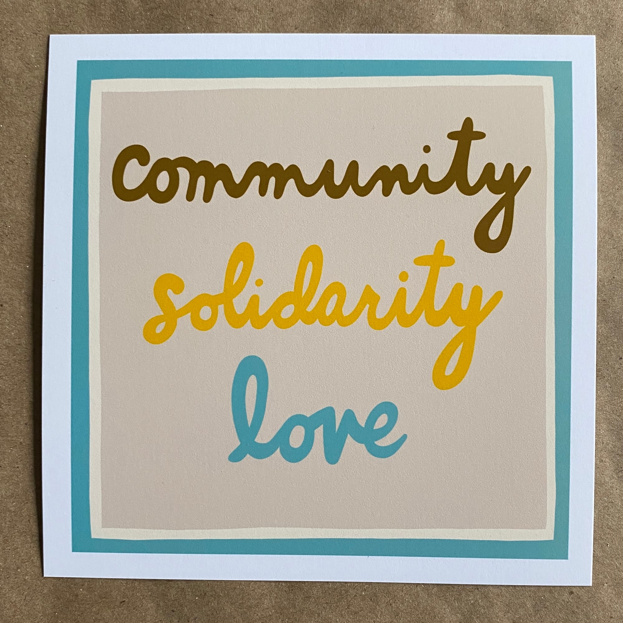 original art by AnneArchy featuring hand lettering of the words "community, solidarity, love"