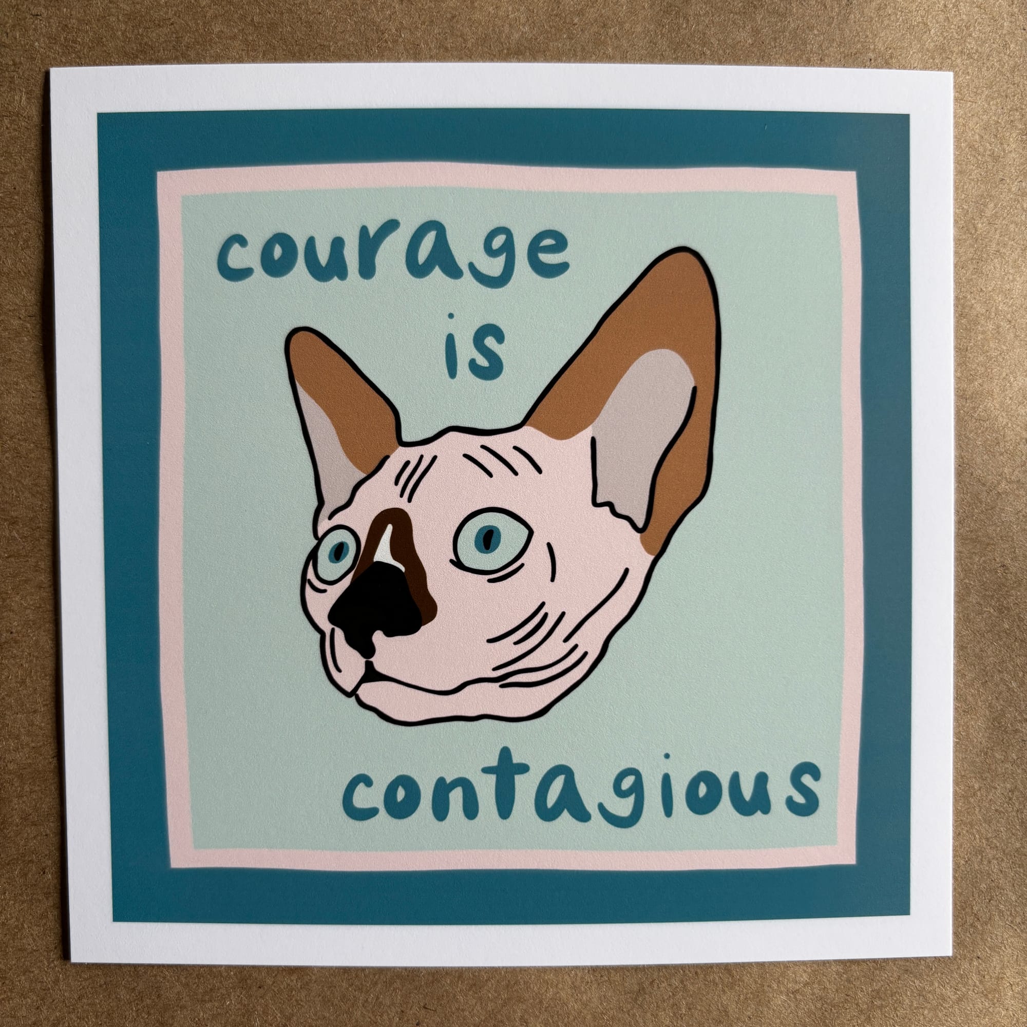 original art by AnneArchy of a hairless cat with hand lettering of the words "courage is contagious"
