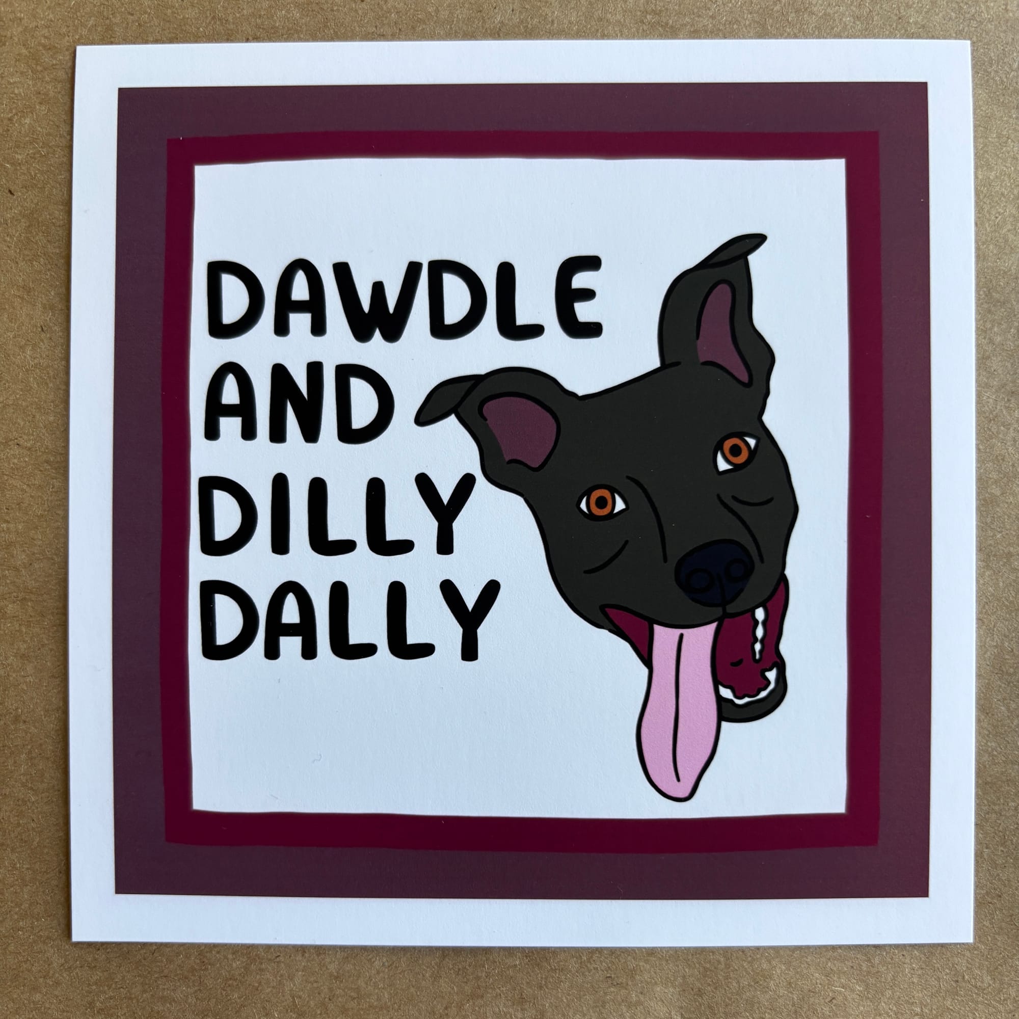 original art by AnneArchy of a black dog with their tongue happily lolling out, with hand lettering of the words "dawdle and dilly dally." 