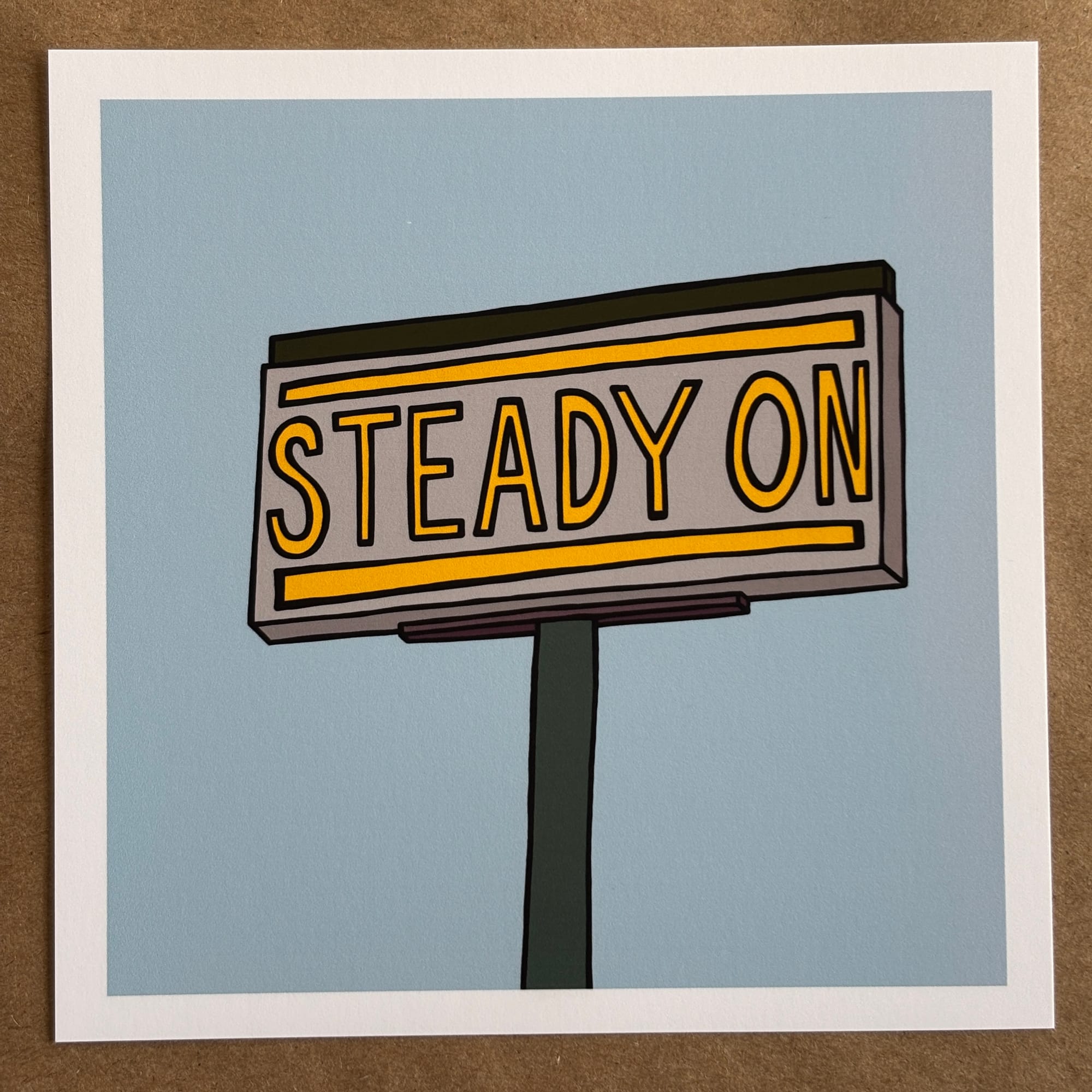 original art by AnneArchy of a billboard style sign against a blue sky with hand-lettering of the words "steady on.”